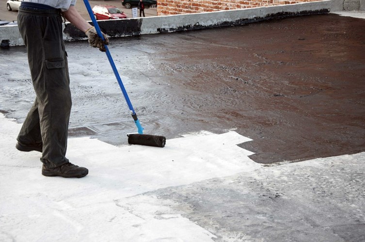 Roof coating being applied by Rhode Island commercial roofers