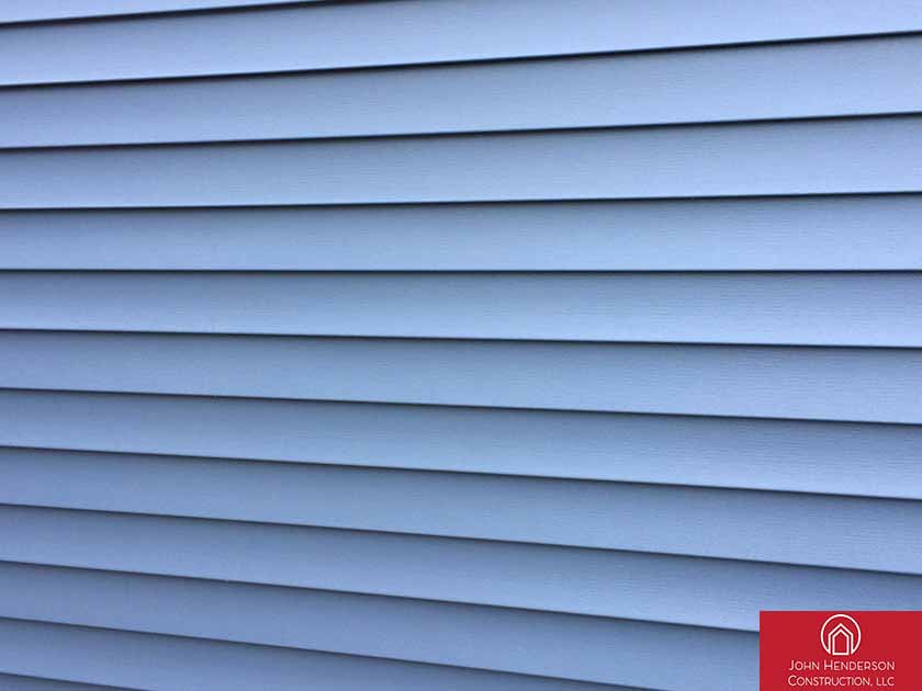 Blue vinyl siding installation