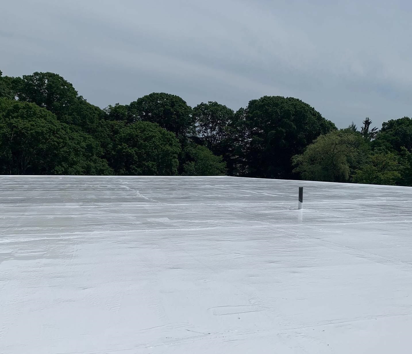 Urethan Roof Coating being installed on a commercial roof in Westerly, RI